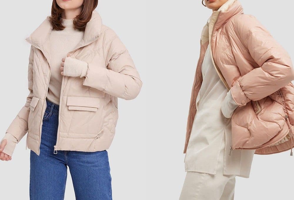 Two models in the Cirrus cropped puffer in oat and blush clay against a grey studio wall