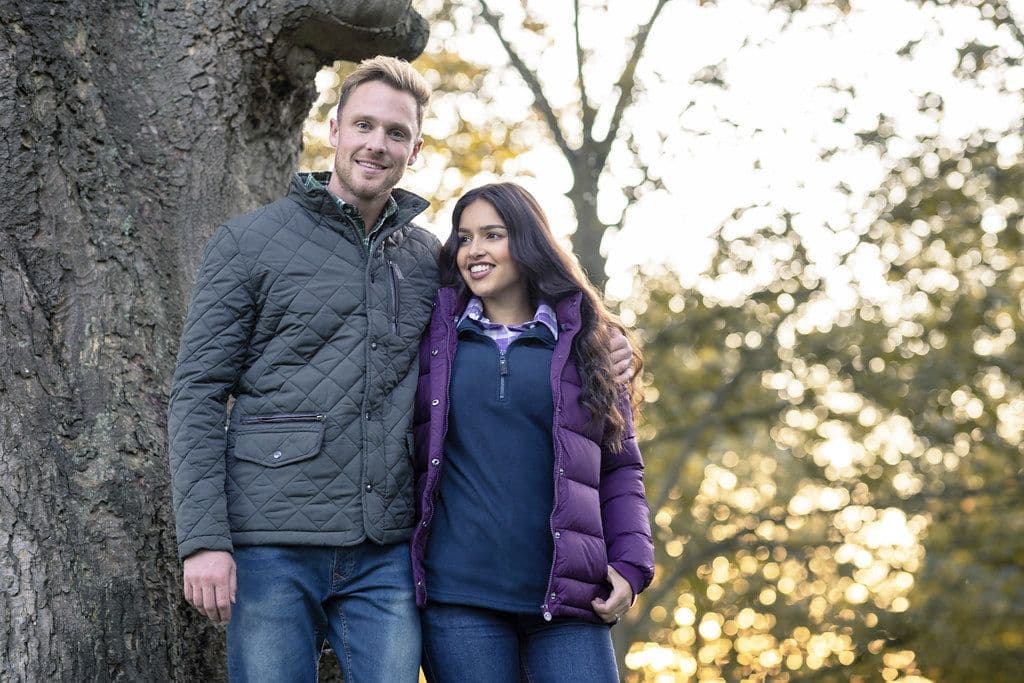 Cirrus Cropped Puffer, alternate view: Couple outdoors among autumn trees, she in a plum quilted puffer